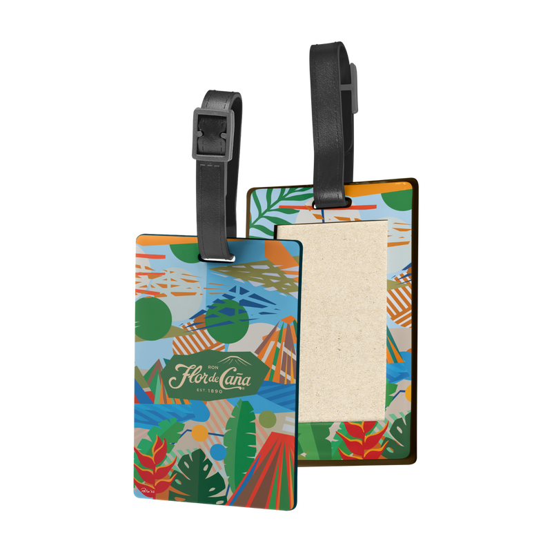 <h2>
<meta charset="utf-8">¡Personaliza tu viaje!</h2>
<p> </p>
<p>Haz que tu maleta sea inconfundible con el nuevo Luggage Tag de <b>Flor de Caña</b>, diseñado con el arte vibrante de <b>Rodolfo Peña</b>. Únete al selecto grupo de viajeros que llevan estilo y seguridad a cualquier destino.</p>